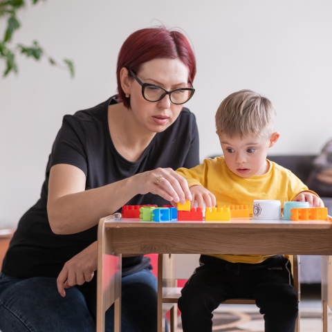 Woman interacts with young child