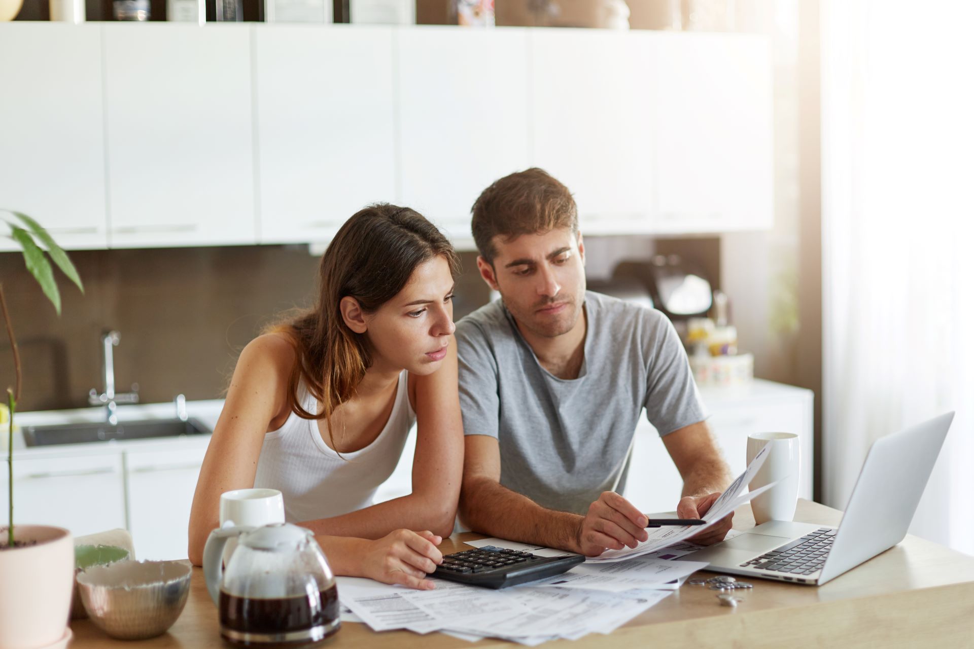 Couple looking at computer and discussing finances