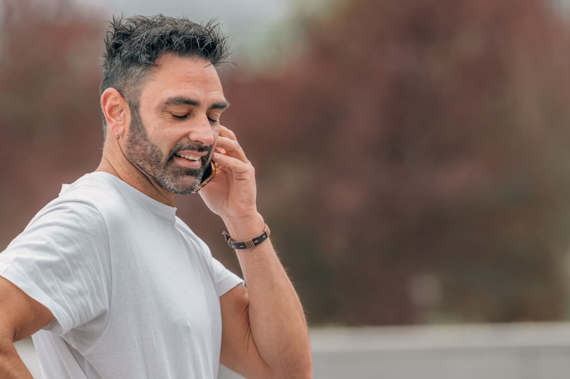 Healthy middle-aged man talking on phone