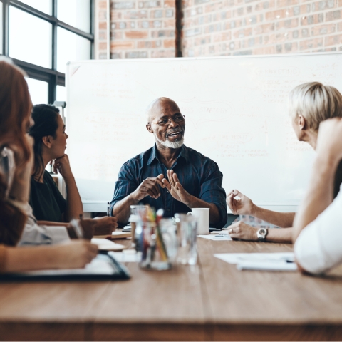 Mixed group of employees share a laugh