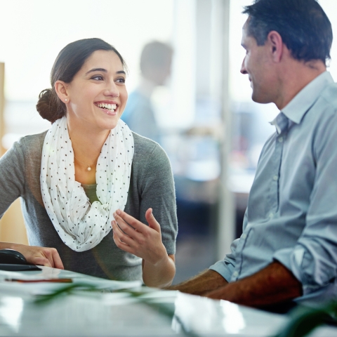 Two employees have a friendly conversation