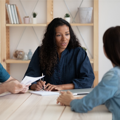 Woman leads discussion with two other individuals